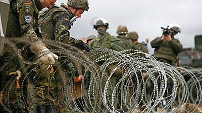 Kfor soldiers from Germany remove a barricade in the village of Jagnjenica on Monday.