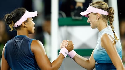 Naomi Osaka, left, shakes hands with Kristina Mladenovic, right, after losing to her at the Dubai Duty Free Tennis Championships in February. EPA