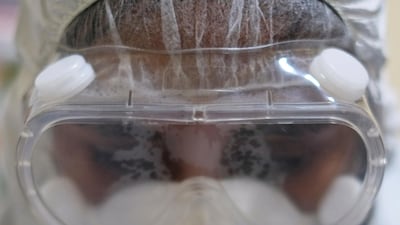 A medical worker looks through safety goggles during a voluntary rapid antigen testing campaign for Covid-19 at the Sopocachi market in La Paz, Bolivia. Reuters