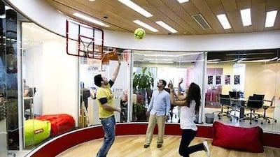 From Left, Conan Gregory, account executive, Waqas Paracha, account manager, and Zaina Nasser, account executive, play a game of basketball at the TBWARAAD MENA region office. Sarah Dea / The National