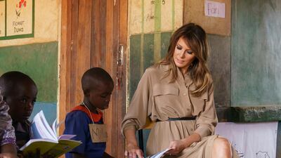 First lady Melania Trump helps a student as she visits a language class at Chipala Primary School, in Lilongwe, Malawi. Carolyn Kaster / AP Photo