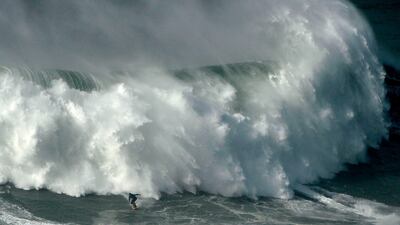 Portuguese surfer Hugo Vau rides a wave during the big waves Nazare Tow Surfing Challenge in Portugal. AFP