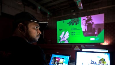 A digital technician arranges a presentation before a preview at Cinema Akil