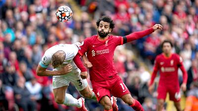Liverpool's Mohamed Salah and Charlie Taylor of Burnley battle for a header. PA