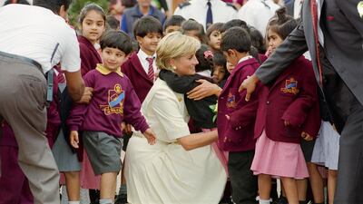 Diana, Princess of Wales embraces a pupil at the Shri Swaminarayan Mandir in Neasden. Getty Images