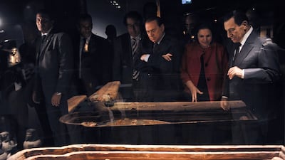 Mr Mubarak, right, speaks with the director of the Egyptian Museum in Cairo, next to Mr Berlusconi, during their visit at the Egyptian Academy in Rome. AFP