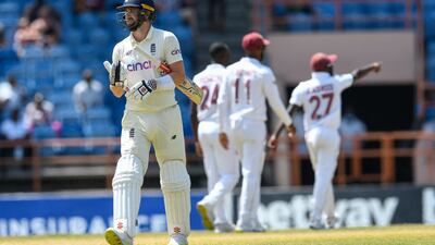 England batsman Chris Woakes of England walks off the field after being dismissed by Kemar Roach for 19. AFP