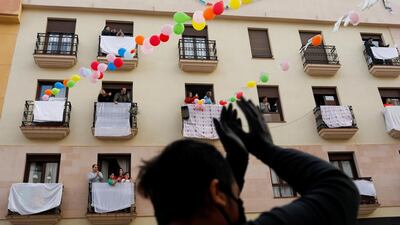 Neighbours celebrate the engagement of Juan Manuel Zamorano, 32, and Elena Gonzalez, 31, after she proposed to him at the balcony of their house in downtown Ronda, southern Spain. Reuters