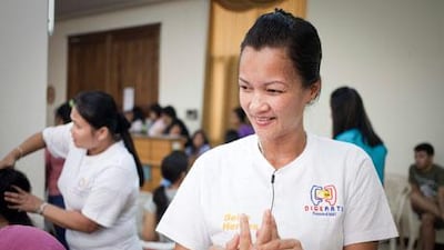 Marita Masacote, a massage therapist at the Filipino Digerati Association demonstrates massage techniques to a runaway maid being cared for at the Filipino labour office shelter. Razan Alzayani / The National
