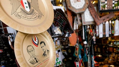Souvenir plates bearing the Syrian flag and the portraits of Russian President Vladimir Putin and Syrian President Bashar Al Assad are pictured in a shop in a bazaar in old Damascus. AFP