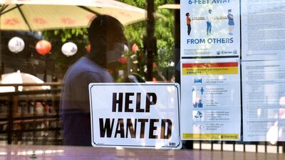 A 'Help Wanted' sign is posted beside Coronavirus safety guidelines in front of a restaurant in Los Angeles, California. Following over a year of restrictions due to the coronavirus pandemic, many jobs at restaurants, retail stores and bars remain unfilled, despite California's high unemployment rate, causing some owners to fear they will not be able to fully reopen by the June 15th date California has given for a full reopening of the economy. AFP