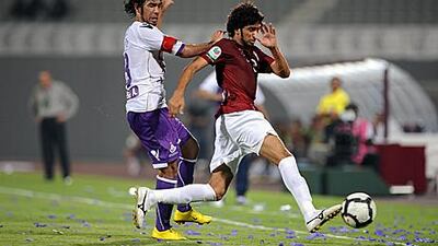 Al Wahda’s Yaqoub al Hosani, right, vies for the ball with Shehab Ahmed of Al Ain last night. Shadi Malkawi / Al Ittihad