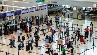 Tourists wait to check in at the airport in Cancun, Mexico. In Quintana Roo state, where Cancun is located, tourism is the only industry there is, and Cancun is the only major Mexican resort to reopen so far. AP Photo