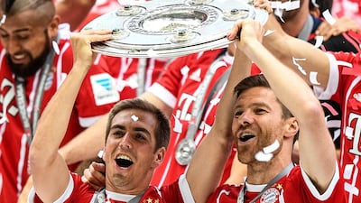 Philipp Lahm, left, and Xabi Alonso, lift the Bundesliga shield after Bayern Munich defeated Freiburg in Munich, Germany on Saturday, May 20, 2017. The pair will now retire from football. Christian Bruna / EPA