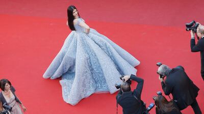 The blue off-the-shoulder dress featuring detailed beading, embroidery and a voluminous skirt, is from Cinco's Impalpable Dream of Versailles collection. Getty Images