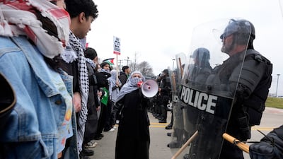 Pro-Palestinian demonstrators face police during a visit by US President Joe Biden to Warren, Michigan. AP
