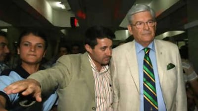The retired Turkish general Hursit Tolon (right), flanked by police officers, is taken for a medical check up after he was detained by police.