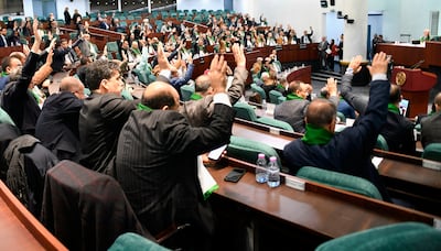 Members of the Algerian Parliament voting to pass the new legislation. AP