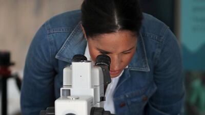 Meghan, Duchess of Sussex looks through a microscope as she visits Waves for Change, an NGO, at Monwabisi Beach with Prince Harry, Duke of Sussex in Cape Town, South Africa. Waves for Change supports local surf mentors to provide mental health services to vulnerable young people living in under resourced communities. Getty Images