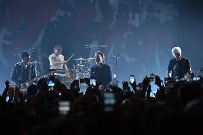 The Edge, left, Larry Mullen Jr, Bono and Adam Clayton of U2 perform during a concert at the Apollo Theatre. AP