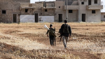 Turkish-backed Syrian rebel fighters walk at a position along the battle frontlines with the Syrian Democratic Forces (SDF) in Syria's northern city of Manbij, in June 2022. AFP