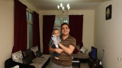 Irfan Awan, seen here with his son Rehan, leased a two-bedroom apartment in Al Barsha for Dh67,000 in June last year, but was recently sent an email and letter specifying that the rent would increase by Dh5,000 on renewal in June. Pawan Singh / The National