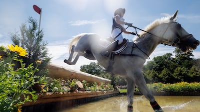 Noor Slaoui of Morocco jumps over a course obstacle with her horse Cash In Hand during the Eventing Cross Country competition. EPA