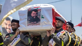 Mourners attend a funeral ceremony for three Lebanese Civil Defense members in Tyre, southern Lebanon, on Thursday. Reuters