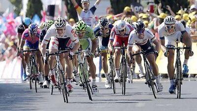 A teammate, rear, starts celebrating after watching Andre Greipel, left in white, sprints towards the finish line ahead of Peter Sagan, in green, to win the sixth stage of the Tour de France in Montpellier. Laurent Cipriani / AP Photo