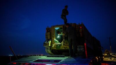 Turkish soldiers prepare an armoured vehicle as Turkish armed forces drive towards the border with Syria near Akcakale in Sanliurfa province. AFP