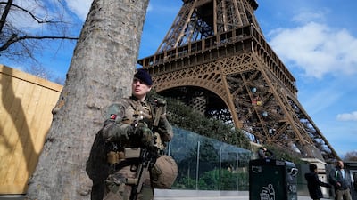 A soldier on patrol at the Eiffel Tower on Monday with France on high alert after the attack in Russia on Friday. AP