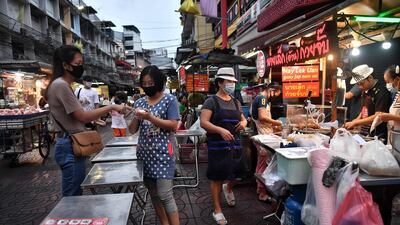 Street food vendors in masks in Chinatown in Bangkok. AFP