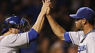 Los Angeles Dodgers' closer Ramon Troncoso, right, celebrates with catcher Russell Martin after they defeated the Chicago Cubs 2-1.