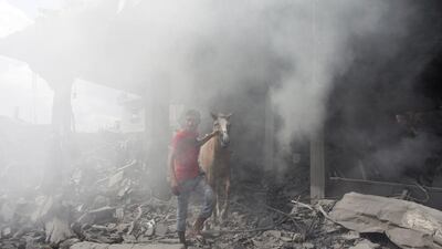 A Palestinian man rescues his horse from the rubble of homes destroyed by Israeli military forces in the northern district of Beit Hanoun in the Gaza Strip.