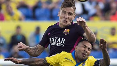 Barcelona’s French defender Lucas Digne, top, vies with Las Palmas forward Jonathan Viera. Jaime Reina / AFP