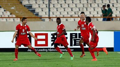 Al Ahli players rush to celebrate with Lima, left, fter the striker scored the only goal of the Asian Champions League quarter-final first leg against Naft Tehran. Abedin Taherkenareh / EPA