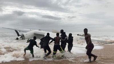 People pull the wreckage of a propeller-engine cargo plane after it crashed in the sea near the international airport in Ivory Coast's main city, Abidjan, on October 14, 2017. Ange Aboa / Reuters