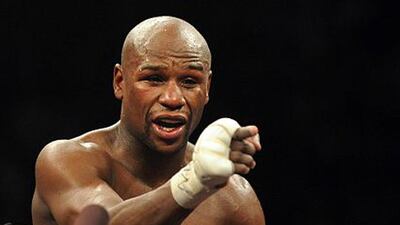 Boxer Floyd Mayweather gestures to the crowd after defeating Miguel Cotto in May 2012.