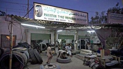 Workers at Pakistan Tyre Repairing Workshop on Mohammed Bin Saqr Al Qasimi Road, the main road for trucks through Ras al Khaimah City. Jeff Topping / The National