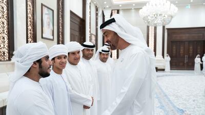 Sheikh Mohamed bin Zayed (right), receives members of Adheedak group during an iftar reception at Al Bateen Palace. Eissa Al Hammadi for the Ministry of Presidential Affairs
