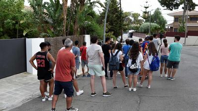 Fans gather outside the home of Lionel Messi in Barcelona on August 9, 2021.