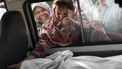 The sister of Aftab Bahadur touches her brother's face after his body was placed in a van to be taken for burial following his execution at Kot Lakhpat jail in Lahore, Pakistan. Mohsin Raza/Reuters