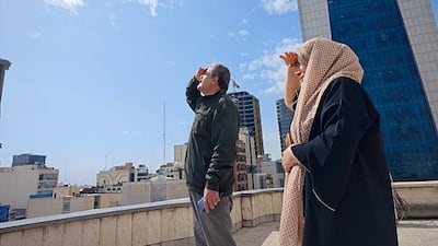Tehran residents look the skies amid widespread attacks in in Iran by the US and Israel, on February 28, 2026. Getty