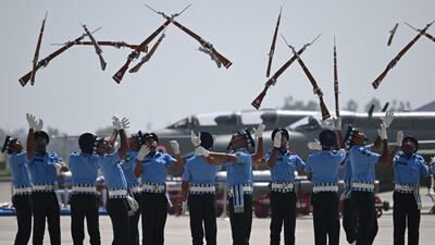 Air force cadets throw their rifles in the air during a dress rehearsal for the MIG-21 Bison fighter jet retirement ceremony, in Chandigarh, northern India. AFP