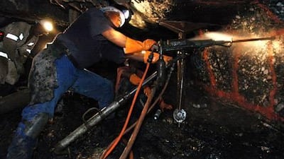 Miners drill underground at AngloGold Ashanti’s Mponeng gold mine near Carltonville, South Africa. Naashon Zalk / Bloomberg News