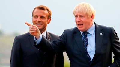 British Prime Minister Boris Johnson (right) gestures past French President Emmanuel Macron at the Biarritz lighthouse, southwestern France, ahead of a working dinner on the first day of the annual G7 Summit. AFP
