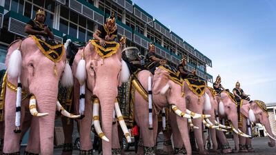 Mahouts ride on painted elephants as they march to pay their respects to Thailand's late queen Sirikit in Bangkok. AFP