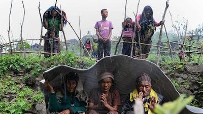 Nepalese villagers shelter from rain during relief operations at Lapu in Gorkha on April 28, 2015, four days after a 7.8-magnitude earthquake rocked Nepal killing thousands. Sajjad Hussain/AFP Photo