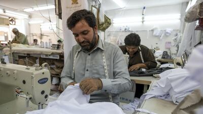 Tailors at a garment shop in Satwa prepare and finish sowing Eid clothes for the upcoming end of the Holy Month of Ramadan. Antonie Robertson / The National