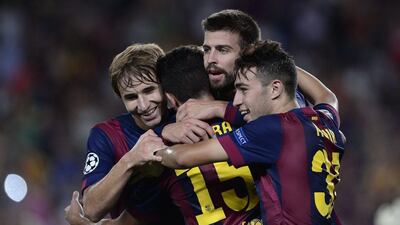 Barcelona's Sergi Samper left, celebrates with Gerard Pique, centre, after Pique's goal in Barca's 1-0 win over Apoel Nicosia on Wednesday in the Champions League. Josep Lago / AFP / September 17, 2014